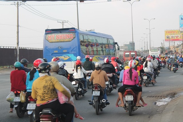 Trong khi bến xe hối hả đón trả khách thì phía ngoài quốc lộ cũng nhộp nhịp những dòng xe đổ về Sài Gòn