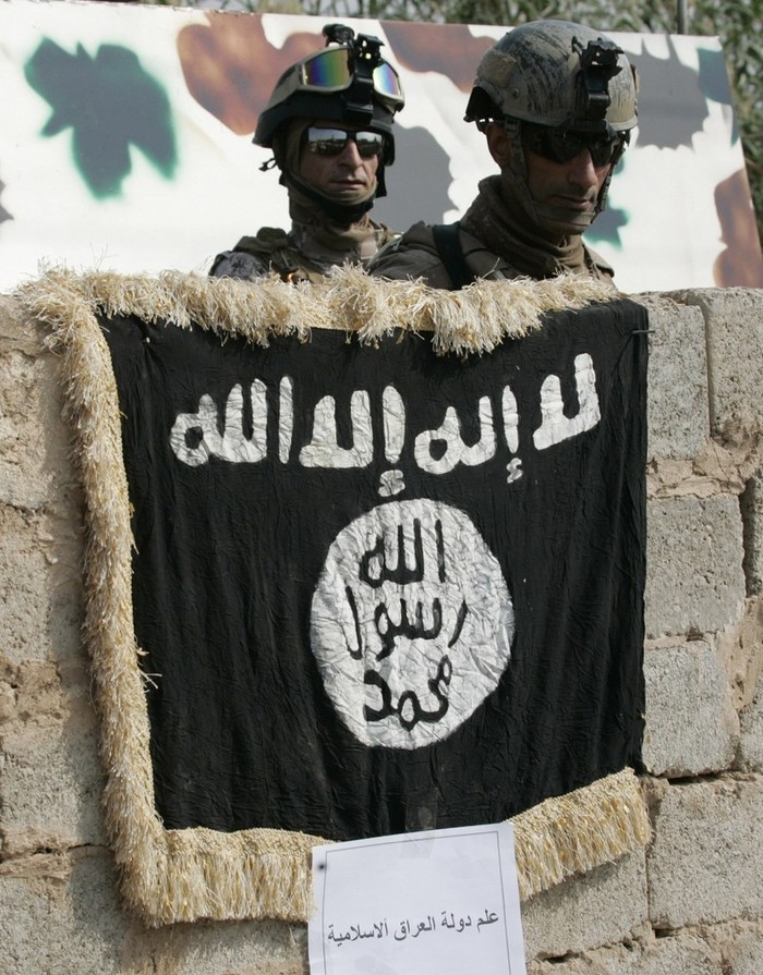 Nhà chức trách Iraq cho biết một phiến quân tình nghi là khủng bố đã bị bắt giữ và ngay sau đó một cuộc bao vây đã được tiến hành để khống chế và thu giữ kho vũ khí này. Trong ảnh là lá cờ của tổ chức khủng bố có liên quan đến Al-Qaeda được treo trên tường của ngôi nhà có vũ khí được cất giấu.