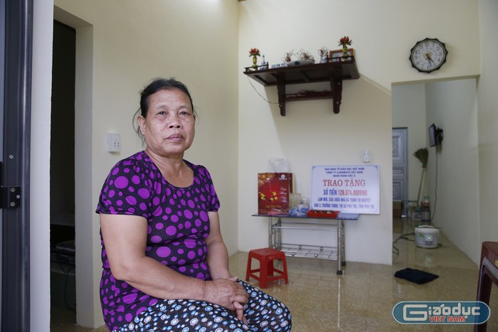 Bà Trịnh Thị Nguyệt ngồi trong căn nhà của mình sau khi được làm mới và sửa chữa. Ảnh: Tùng Dương.