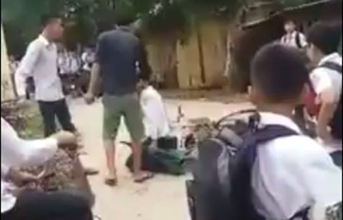 Bùi Quang Huy (học sinh lớp 8A, Trường THCS Âu Lâu, TP Yên Bái) bị đánh và bị bắt quỳ xin lỗi giữa đường. ảnh chụp từ clip.
