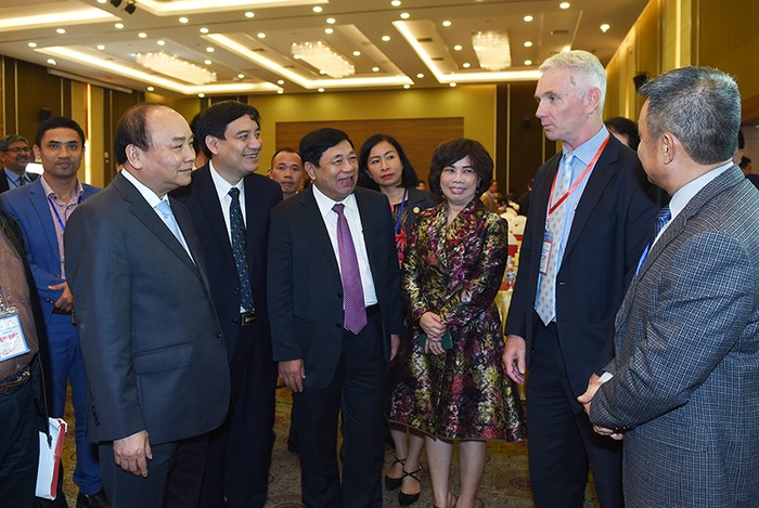 Thủ tướng trao đổi với các nhà đầu tư tham dự hội nghị. Ảnh: VGP/Quang Hiếu.
