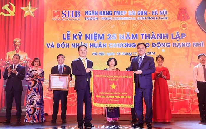 Ủy viên Bộ Chính trị, Phó Thủ tướng Chính phủ Vương Đình Huệ thay mặt Đảng và Nhà nước trao Huân chương Lao động Hạng Nhì và Cơ Thi đua của Chính phủ cho Ngân hàng SHB.