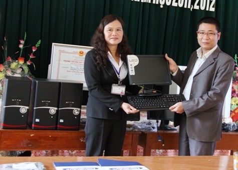 Đại diện siêu thị điệm máy, máy tính Trần Anh trao máy tính và máy in cho Hiệu trưởng nhà trường.