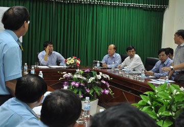 Các ông Đặng Hùng (Giám đốc ACC, đứng, bìa trái) và ông Hoàng Thành (đứng, bìa phải) báo cáo với Bộ trưởng Đinh La Thăng (ngồi giữa) nguyên nhân không thể nâng cấp, kéo dài đường băng đúng hạn. Ảnh: HẢI CHÂU