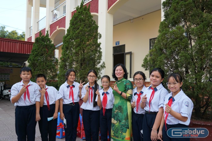 Cô giáo Nguyễn Thị Minh An cùng học sinh lưu giữ kỷ niệm trong ngày lễ đặc biệt (Ảnh: Phạm Linh)