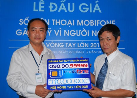 Ông Trần Thế Linh (bên trái) nhận sim số 090.90.99999 tại phiên đấu giá hôm 22/12. Ảnh: Internet