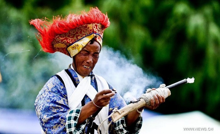 Một người dân Tây Tạng đang đốt súng trong một màn trình diễn tại lễ hội.