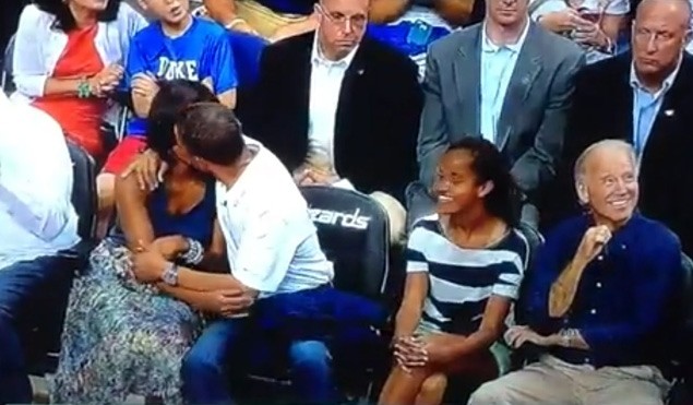 Tổng thống Mỹ Obama ôm hôn vợ khi đang xem bóng rổ.