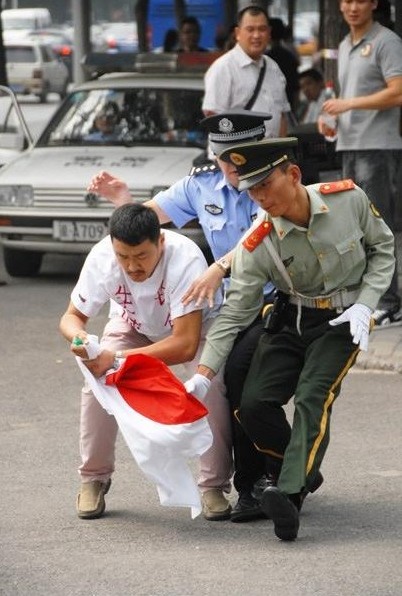 Lực lượng an ninh ngăn cản người đàn ông Trung Quốc đang có hành động quá khích.