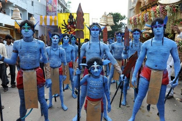 Ở thành phố Hyderabad, người dân mặc, trang điểm như diễn viên Avatar chuẩn bị diễu hành trong lễ hội.