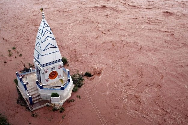 Một ngôi đền bị bao quanh bởi nước lũ từ sông Tawi sau một trận mưa lớn ở Jammu.
