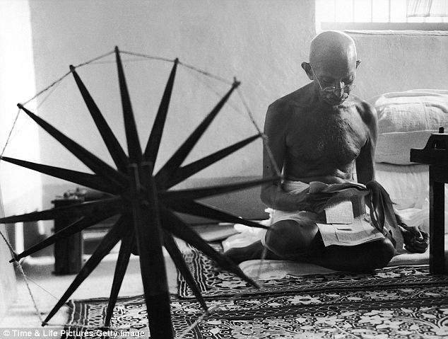 Nhà lãnh đạo Mohandas Gandhi - biểu tượng độc lập của đất nước Ấn Độ - đang ngồi sau một bánh xe quay chỉ dệt thảm