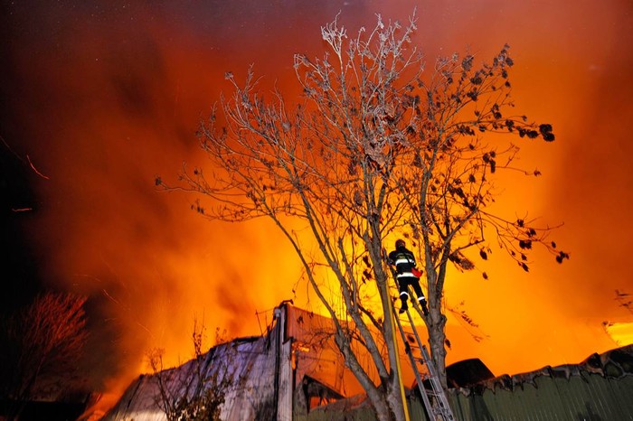 Lính cứu hỏa đang cố gắng dập lửa trong một đám cháy nhà kho chứa giấy cuộn của một xưởng in báo tại Forest-sur-Marque, Pháp hôm 25/11.