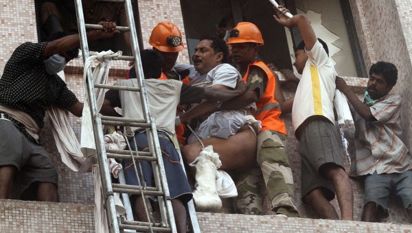 Các nhân viên cứu hỏa nỗ lực đưa các bệnh nhân còn sống ra khỏi tòa nhà đang cháy. Ảnh Reuters