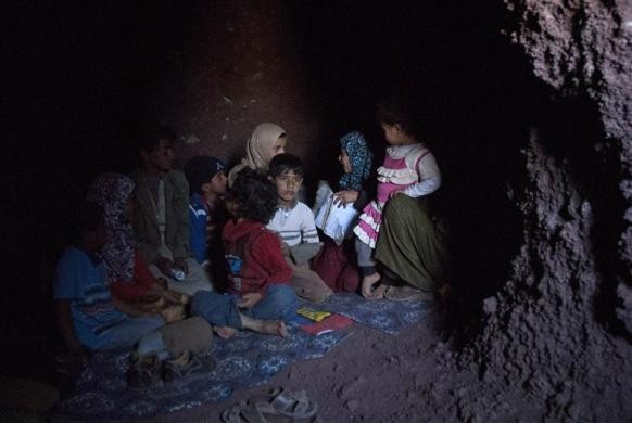 Trẻ em ngồi trong hang động ở miền núi tỉnh Arhab, phía bắc thủ đô Sanaa ngày 6/1. Dân làng sống tại đây thường tìm tới các hang động ẩn náu khi phe đối lập sử dụng bạo lực ép những người trung thành với Tổng thống Yemen Ali Abdullah Saleh phải rời khỏi làng của họ.