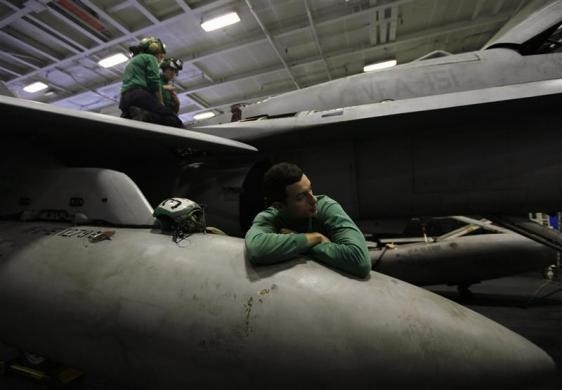 Một thủy thủ tựa lên chiếc VFA-2 trong khoang chứa máy bay ngày 14/2/2012