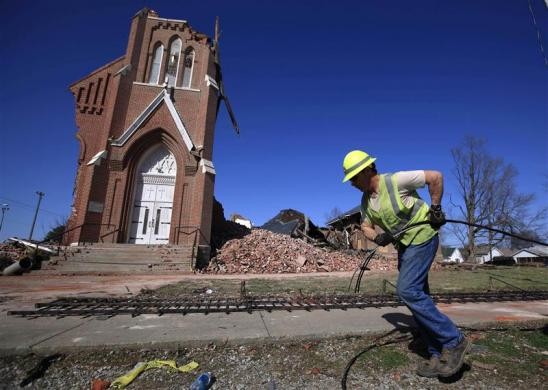Công nhân kéo cáp dọn dẹp đống đổ nát tại nhà thờ thánh Joseph sau trận lốc xoáy hôm 1/3 ở Ridgway, Illinois, Mỹ.