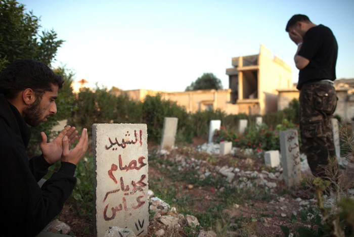 Thành viên của Mugaweer - lực lượng biệt kích của quân đội Syria tưởng niệm đồng đội tại nghĩa trang chôn cất 100 binh sĩ đã thiệt mạng trong các cuộc xung đột tại thị trấn Qusayr ngày 12/5/2012.