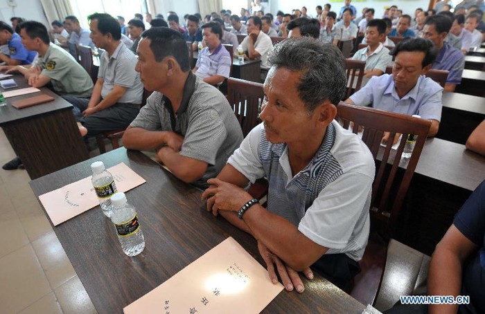 Ngư dân ở thị trấn Đàm Môn, Quỳnh Hải tỉnh Hải Nam tập trung nghe phổ biến thông tin về đánh bắt cá trước khi ra đánh bắt trái phép tại Biển Đông hôm 1/8.