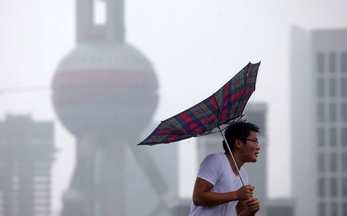 Một người đi bộ cố gắng chống lại cơn gió mạnh tại Thượng Hải.