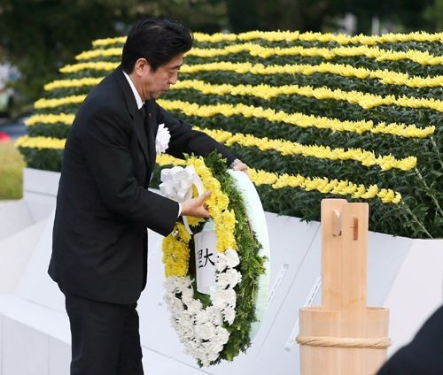 Thủ tướng Nhật Shinzo Abe đặt vòng hoa tưởng niệm tại công viên tưởng niệm hòa bình ở thành phố Hiroshima ngày 6.8 - Ảnh: AFP