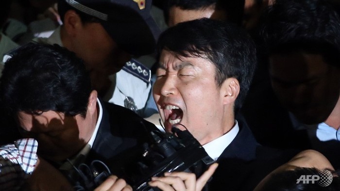 Lee Seok-ki hét lên khi bị các nhân viên an ninh hộ tống vào xe hơi tới nhà tù ở nam thủ đô Seoul.