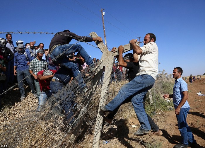 Người Thổ Nhĩ Kỳ phá hàng rào biên giới giúp người Kurd trốn sang lãnh thổ nước này tị nạn.