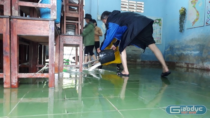 Giáo viên trường Tiểu học số 1 Quảng Vinh dùng nước làm sạch nền nhà.